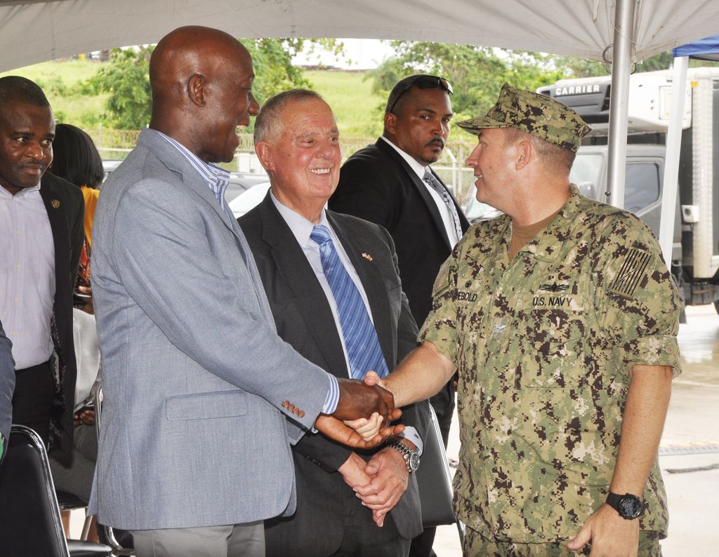 Prime Minister Dr Keith Rowley speaks with Captain Brian J Diebold, right, and Ambassador Joseph Mondello during the closing ceremony of the USNS Comfort in Trinidad at Gate A, Port of Brighton in La Brea, yesterday.