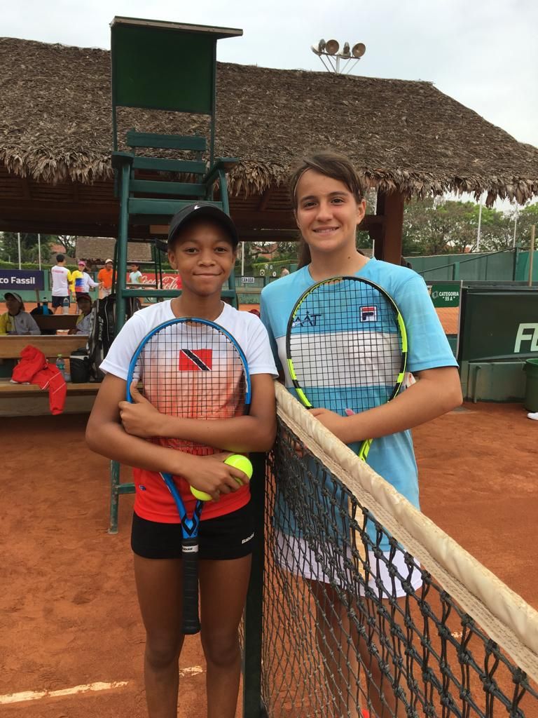 T&T tennis ace Jaeda-Lee Daniel-Joseph and her opponent Carolina Enria after her encounter yesterday. 