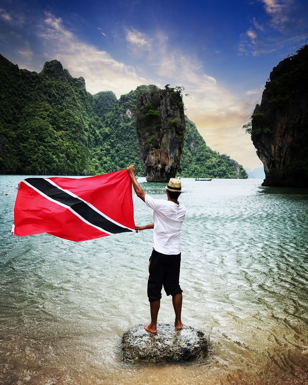 A Trini abroad, a flag in hand, and the world at his feet