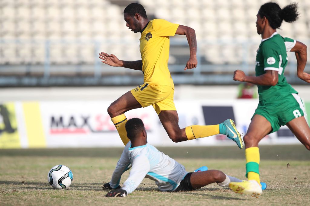 Cunupia FC's Mikheil Peters skips  Erin FC's goalkeeper Tevin Moore to score his 2nd goal, during the TTSL Knock-Out Competition Round 1 Play-offs between 3rd placed Cunupia FC and 14th placed Metal X Erin FC at the Larry Gomes Stadium, Arima on SEptember 2. Cunupia won 7-2.