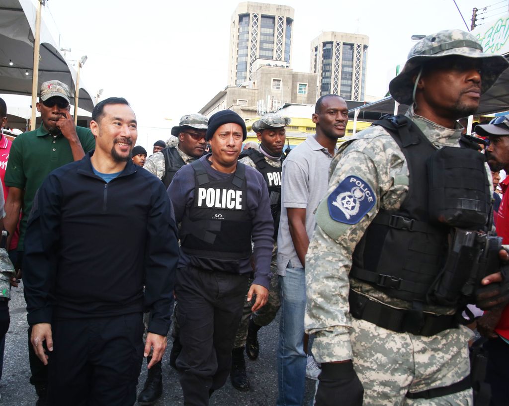 National Security Minister Stuart Young, left, and Commissioner of Police Gary Griffith during their walkabout along South Quay, Port-of Spain during J’Ouvert celebrations yesterday.