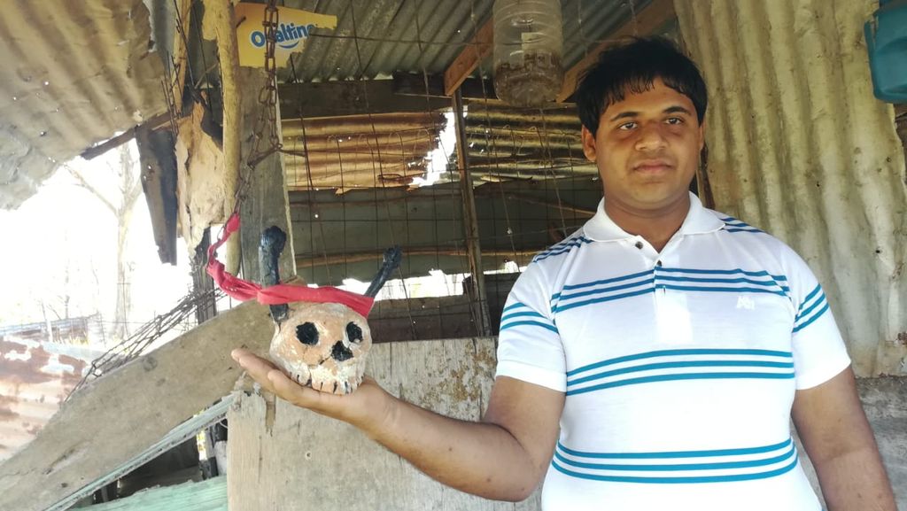 Govinda Matura holds an edifice used as protection against a 'buck' that the Gasparillo family claims has been harrassing them. Photo by Kristian De Silva.
