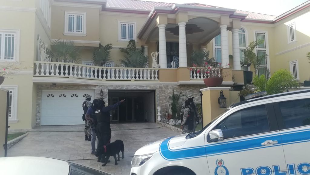 Police officers outside Alexander’s home in Gulf View this morning.