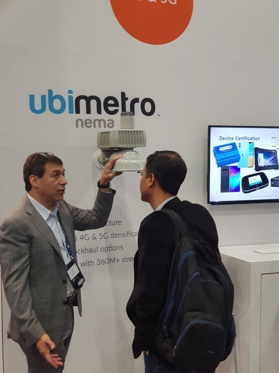 An exhibitor at the GSMA mobile conference in LA shows off the latest crime fighting equipment that allows cameras to turn in the direction of a gunshot whenever it occurs.