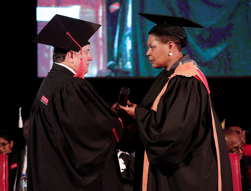 President Paula-Mae Weekes presents executive chairman of the ANSA McAL Group of Companies, Norman Sabga with a honorary doctorate during the University of Trinidad and Tobago’s (UTT’s) graduation ceremony, at the Graduation Pavilion, UTT Campus, O’Meara Industrial Estate, Arima on Wednesday.