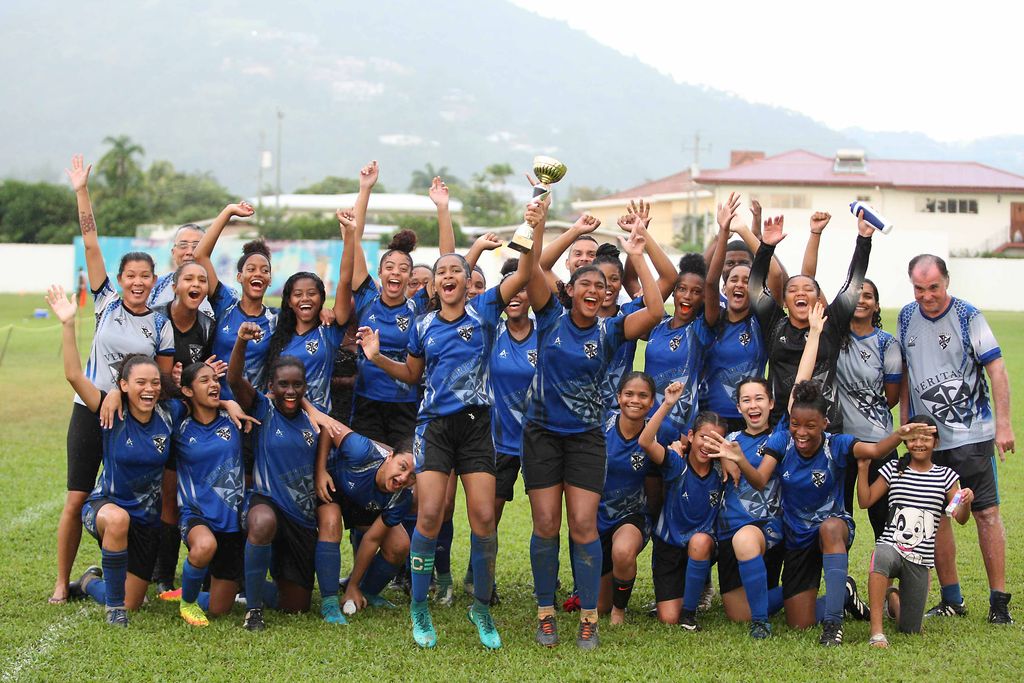 Havana Ramdeen, fifth from left, the captain and Britanny Mahabir, fifth from right at front celebrate with their Holy Name Convent Port-of-Spain team-mates the 2019 Coca Cola Girl’s North Zone title after their 7-2 victory over Bishops Anstey on Sunday at St Mary’s Ground, Port-of-Spain.