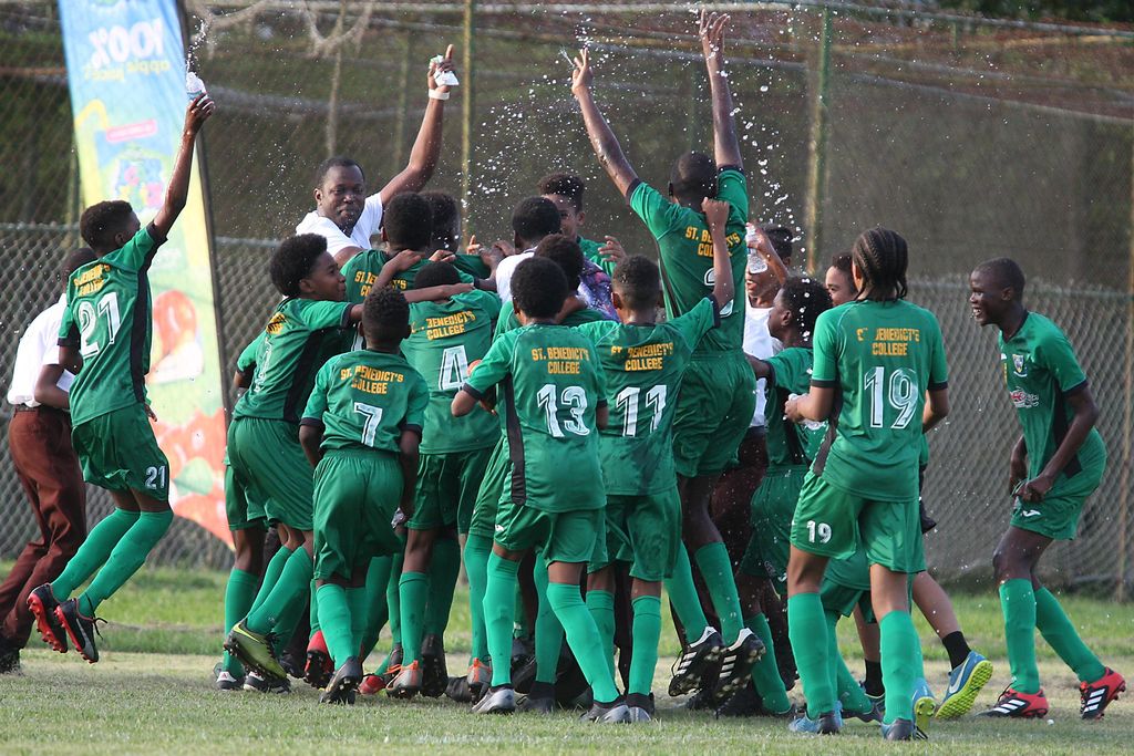 St Benedict’s College players celebrate their 3-1 victory via penalties over East Mu­cu­rapo Secondary School after regulation time ended 0-0 in the Sec­ondary Schools Foot­ball League (SS­FL) Fru­ta Form One Un­der-13 Na­tion­al final at St Mary's Col­lege Ground, St Clair on Tuesday.