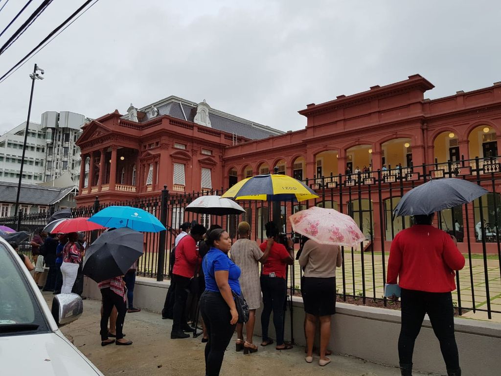 Fans gather outside the Red House to witness the wedding of Machel Montano and Renee Butcher today.
