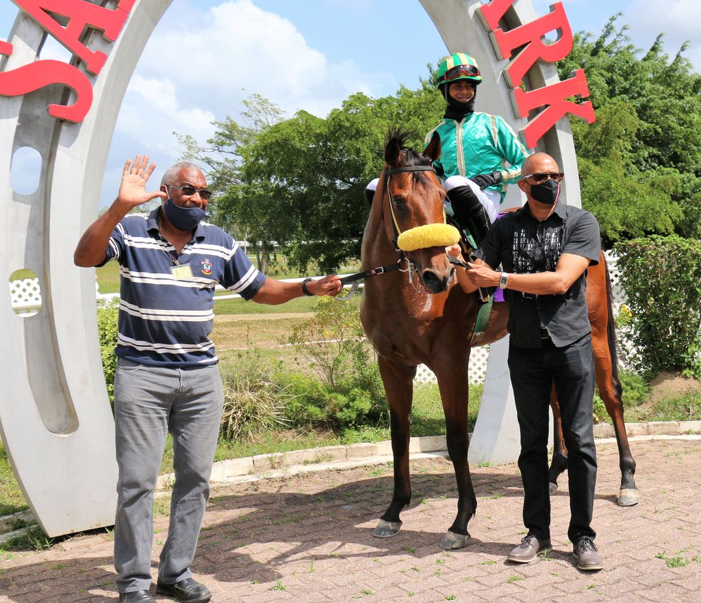 Lance Warner Jnr, left, owner and Gary Neaves in Winner’s Circle with Just Exhale together with apprentice jockey Sven Balroop after the horse won Race 2 on day 8, April 24.