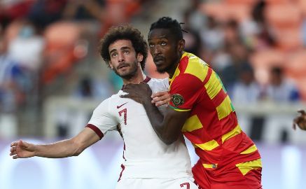 Grenada’s Omar Beckles, right, battles with Ahmed Alaa of Qatar.