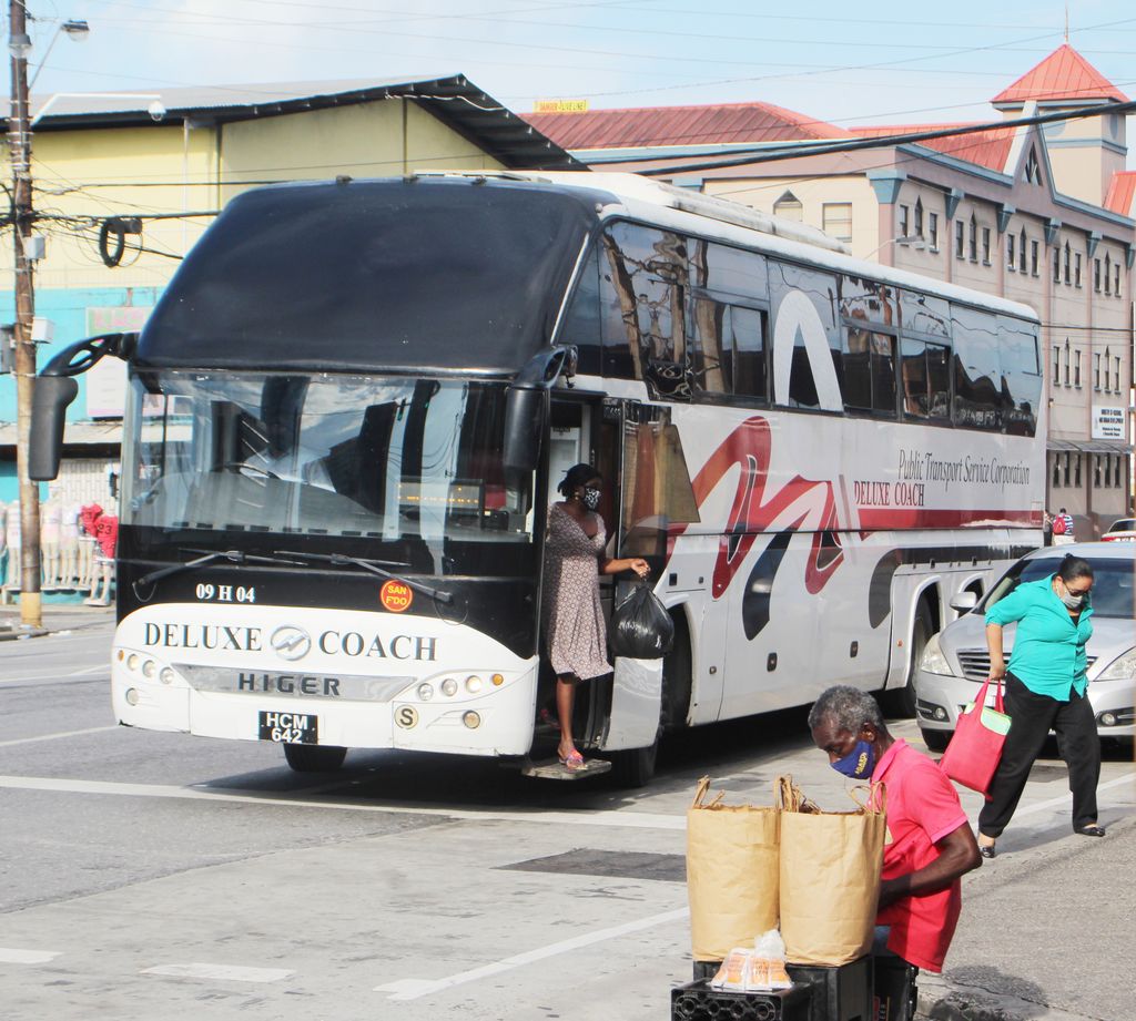 A passanger disembarks from a PTSC bus on South Quay, Port-of-Spain, on Tuesday.