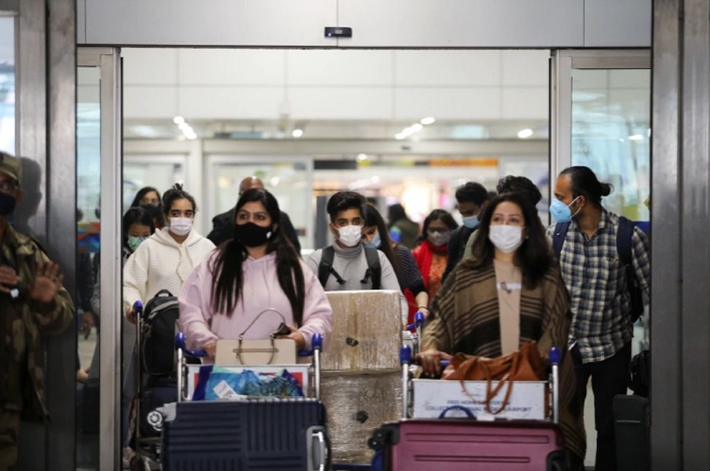 People exit from the arrival section of the Indira Gandhi International Airport in New Delhi [Anushree Fadnavis/Reuters]