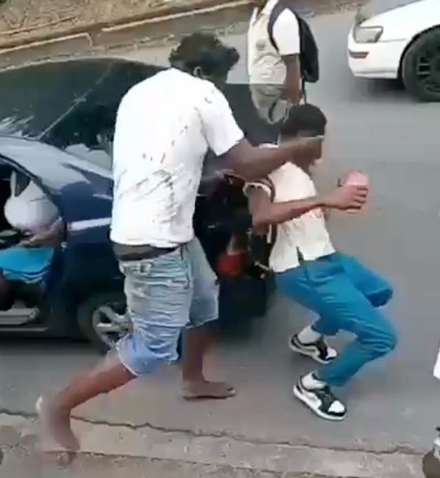 A screengrab of a man slapping a student of the Morvant Laventille Secondary School.