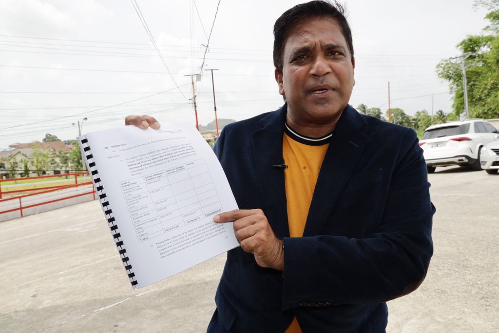 Oropouche East MP Dr Roodal Moonilal shows the arbitration ruling from a London court which upheld Constructora OAS’s arbitration claim against Nidco and ordered the T&T Government to pay US$126.3 million in compensation.