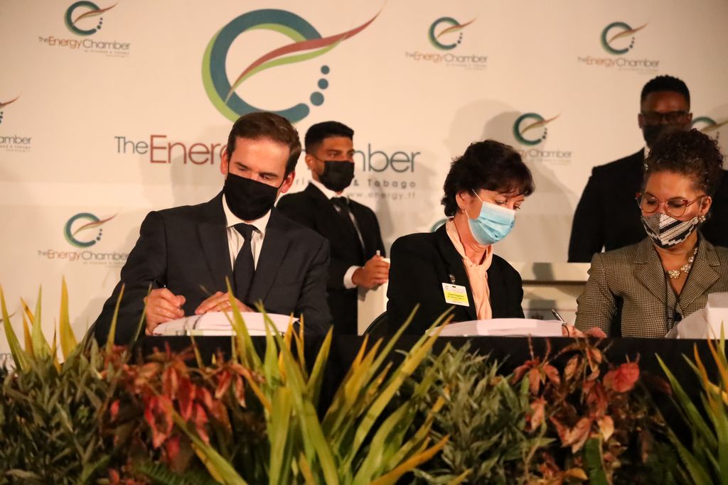 Shell Trinidad and Tobago Limited general manager commercial Stephane Picarle, left, and bpTT president Claire Fitzpatrick both sign documents during the closing of the Trinidad and Tobago deep water competitive bid round 2021/22, at the HYATT Regency, Wrighston Road, Port-of-Spain, yesterday. Looking on at, right, is Ministry of Energy and Energy Industries Senior State Counsel Louise Pay Wing.	