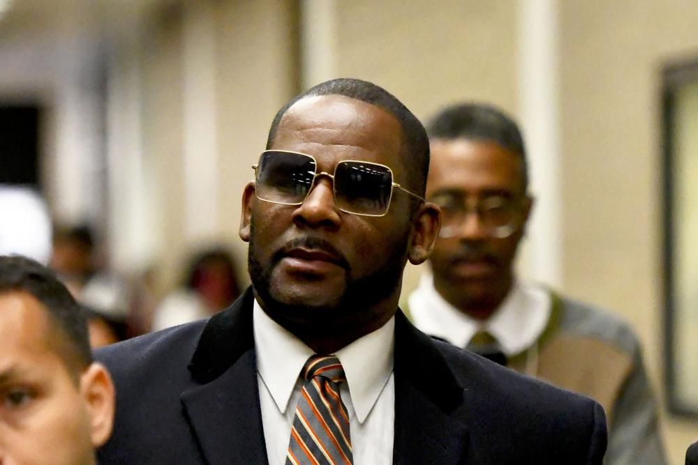 FILE - Musician R. Kelly, center, leaves the Daley Center after a hearing in his child support case on May 8, 2019, in Chicago. Closing arguments are scheduled Monday, Sept. 12, 2022 for R. Kelly and two co-defendants in the R&B singers trial on federal charges of trial-fixing, child pornography and enticing minors for sex, with jury deliberations to follow. (AP Photo/Matt Marton, File)