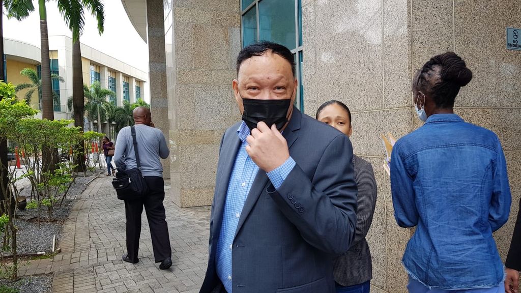 UNC Pointe-a-Pierre MP David Lee leaves Tower C of the Waterfront Complex on Friday.
