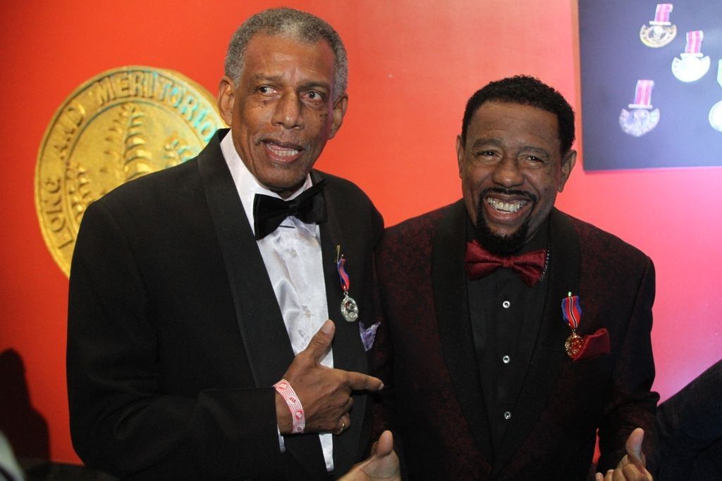 Calypsonians, Willard 'Relator' Harris and Winston 'Explainer' Henry show off their awards after the National Awards Ceremony which was hosted on Republic Day at NAPA, Port of Spain. Relator was awarded the Humming Bird Medal Silver and Explainer the Humming Bird Medal Gold. [Image by DARREN RAMPERSAD]