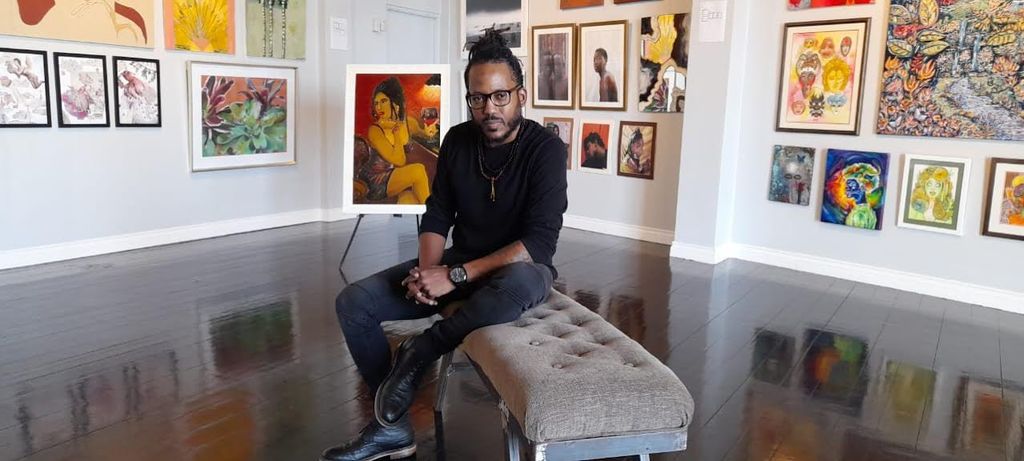  Harande' Elie with his artwork at the Loft gallery.