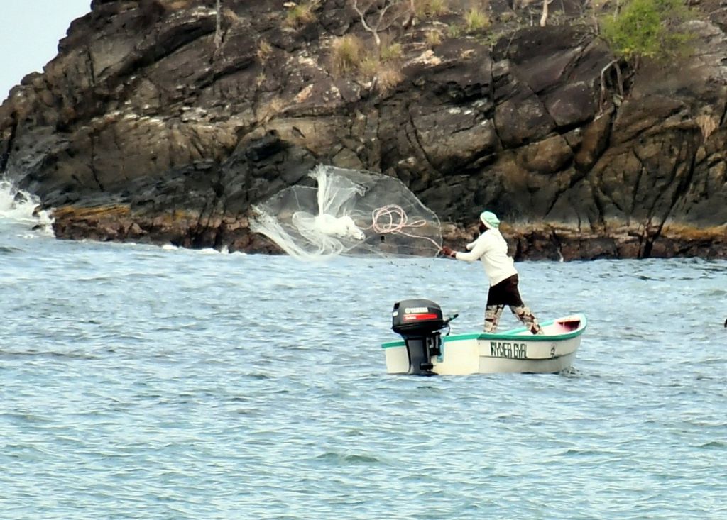 A fisherman casts a net on Sunday morning off Englishman's Bay,  Parlatuvier Bay Tobago