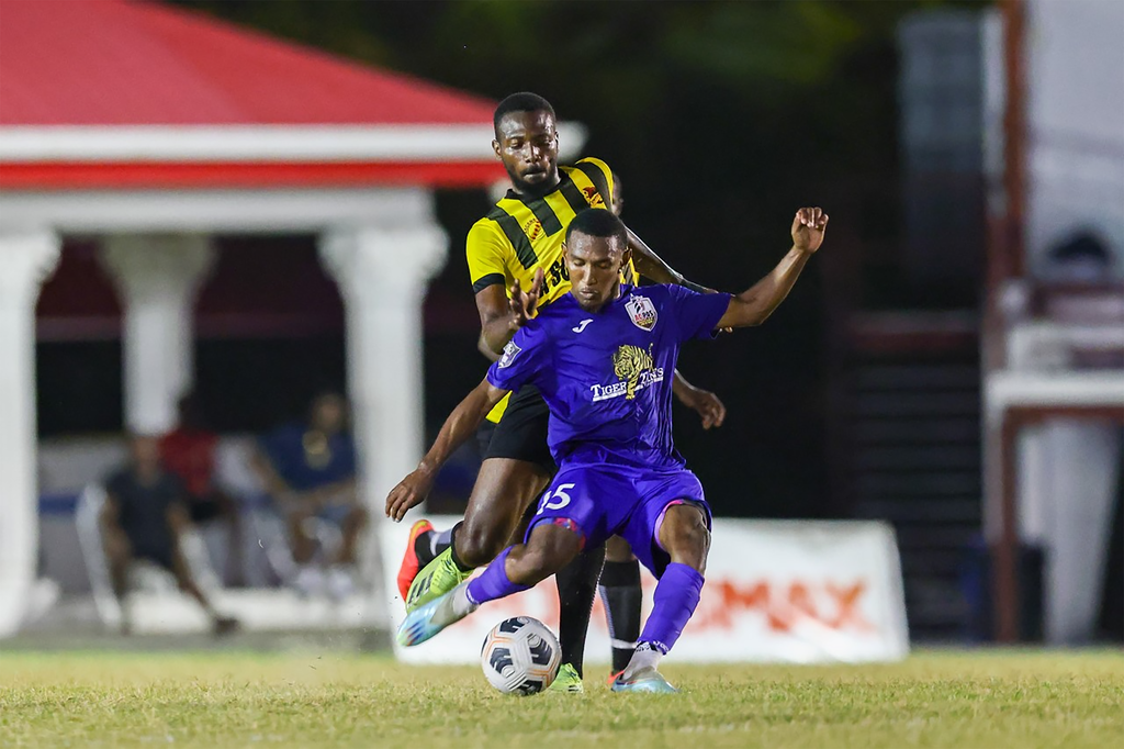 FILE - AC Port-of-Spain’s winger John Paul Rochford, front, tries a shot from half line while under pressure from Central FC Isaiah Smith during the T&T Premier Football League match at the Phase II Recreation Ground in La Horquetta, last month. AC Port-of-Spain won 2-1. On Thursday, Rochford scored the opening goal in AC Port of Spain’s 3-2 win against Central FC at the same venue. 