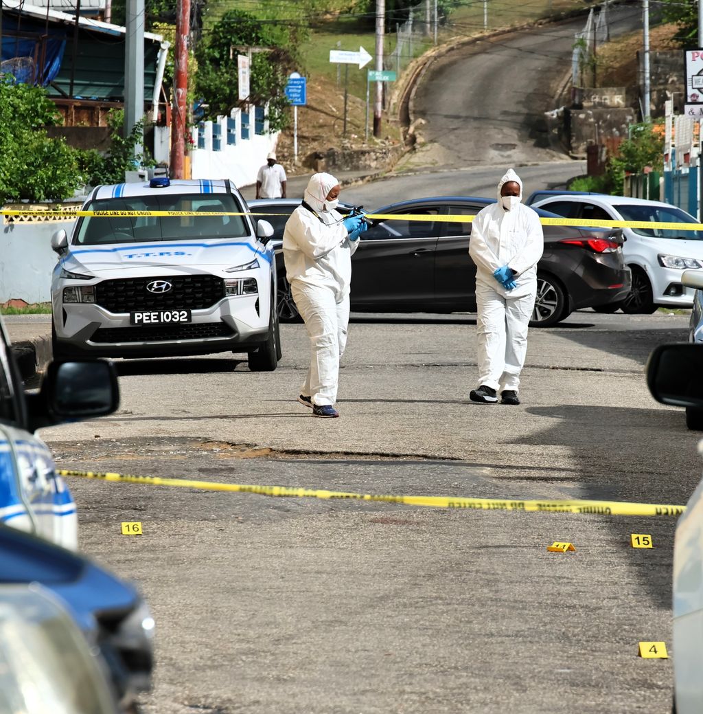 Crime scene investigators record evidence at the scene where Sherwin Findley was killed in Barataria yesterday.