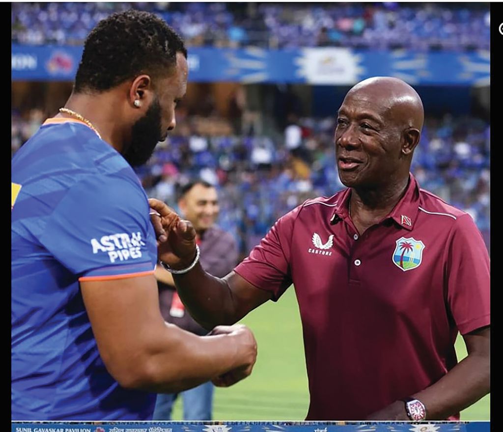 T&T’s PM Dr Keith Rowley is greeted by T&T’s Kieron Pollard of the Mumbai Indians coaching staff before the start of their match against Lucknow Super Giants in the Indian Premier League (IPL) in Mumbai, in May 2024. The PM was present for the coin toss.