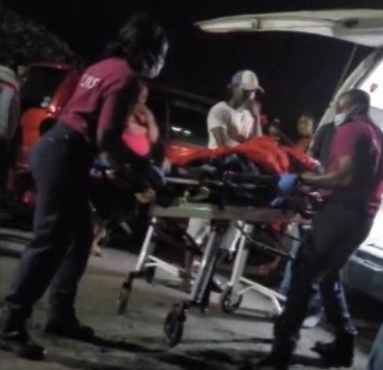The body of Kerdel Amedee being removed from the place where he was shot and killed. [Image courtesy St Lucia Times]