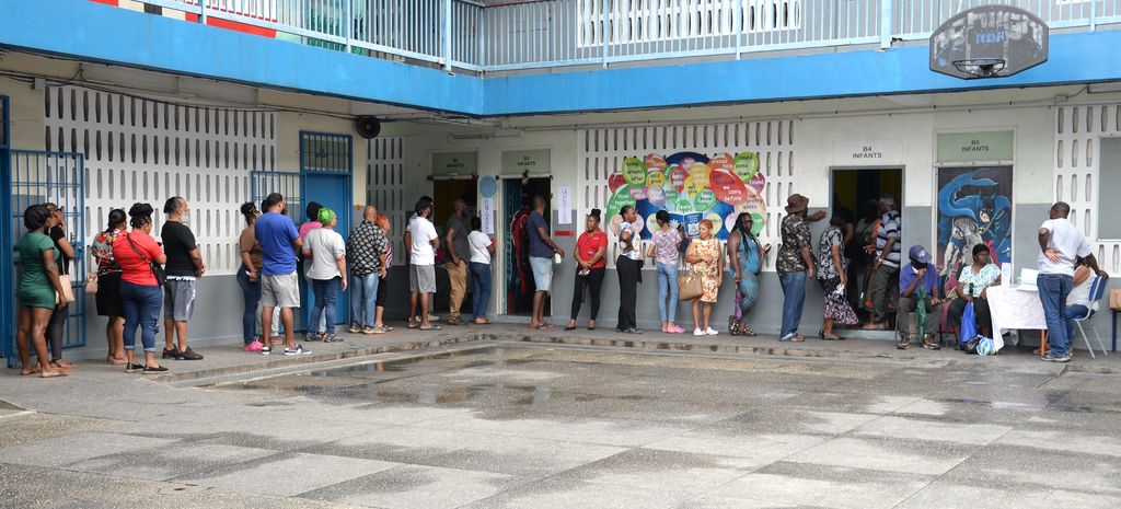 Voters line up to cast their ballots during the People’s National Movement’s internal elections process at the Arima Boys’ Government Primary School, King Street, Arima, on Sunday.