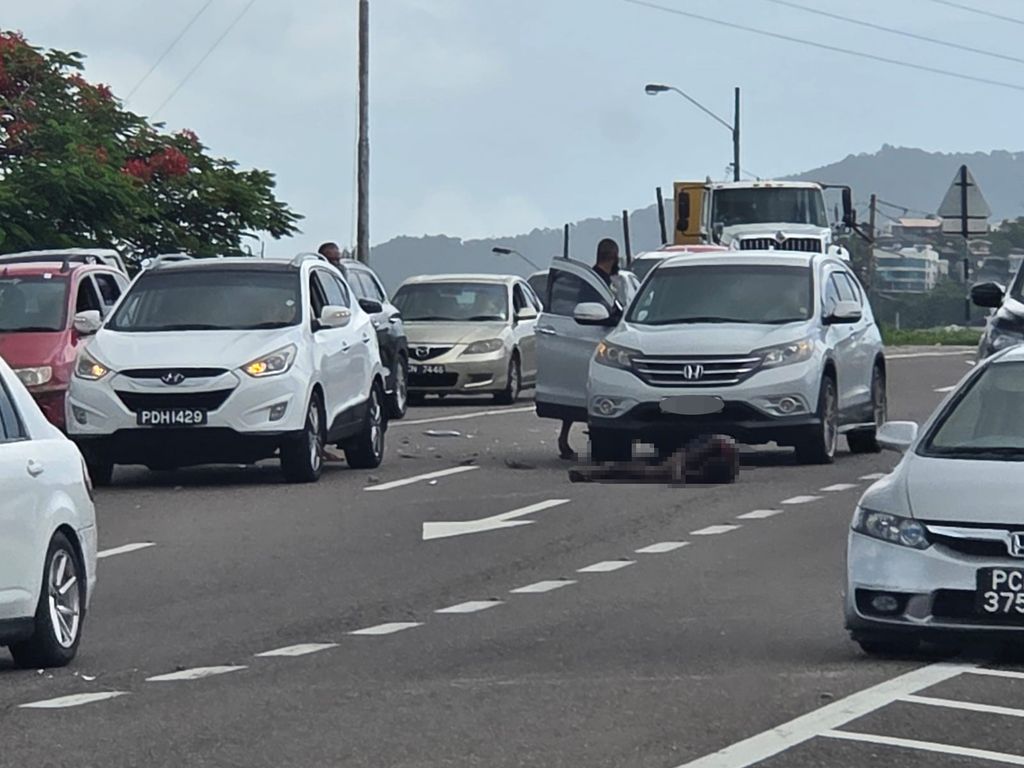 The body of a homeless man lies on the eastbound lane of the Western Main Road, Cocorite, after he was killed in an accident.                                                                                                                                                              