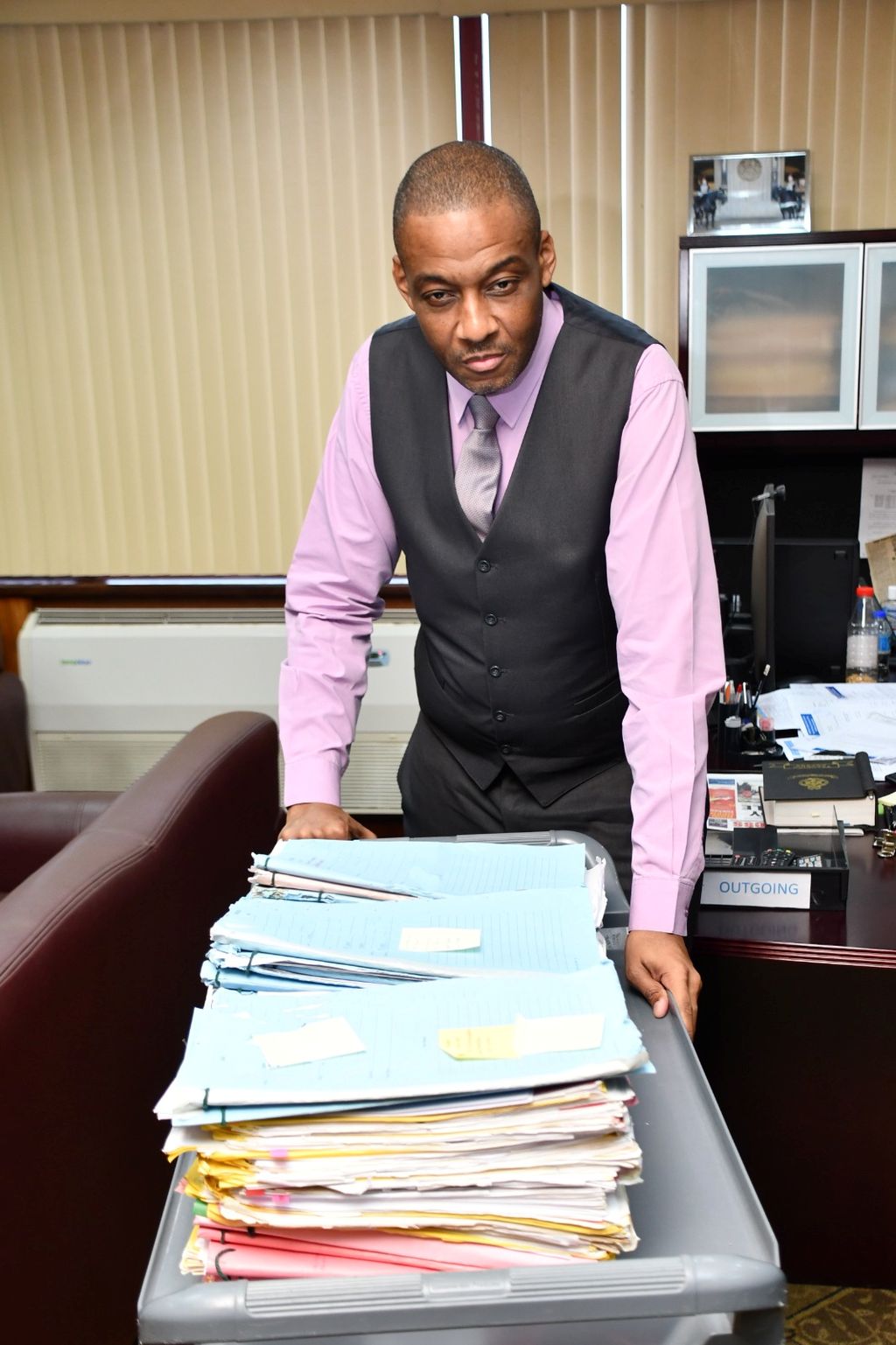 Police Commissioner Allister Guevarro with the first batch of completed Firearm Users Licence (FUL) applications in his office at the Police Administration Building, Port-of-Spain.