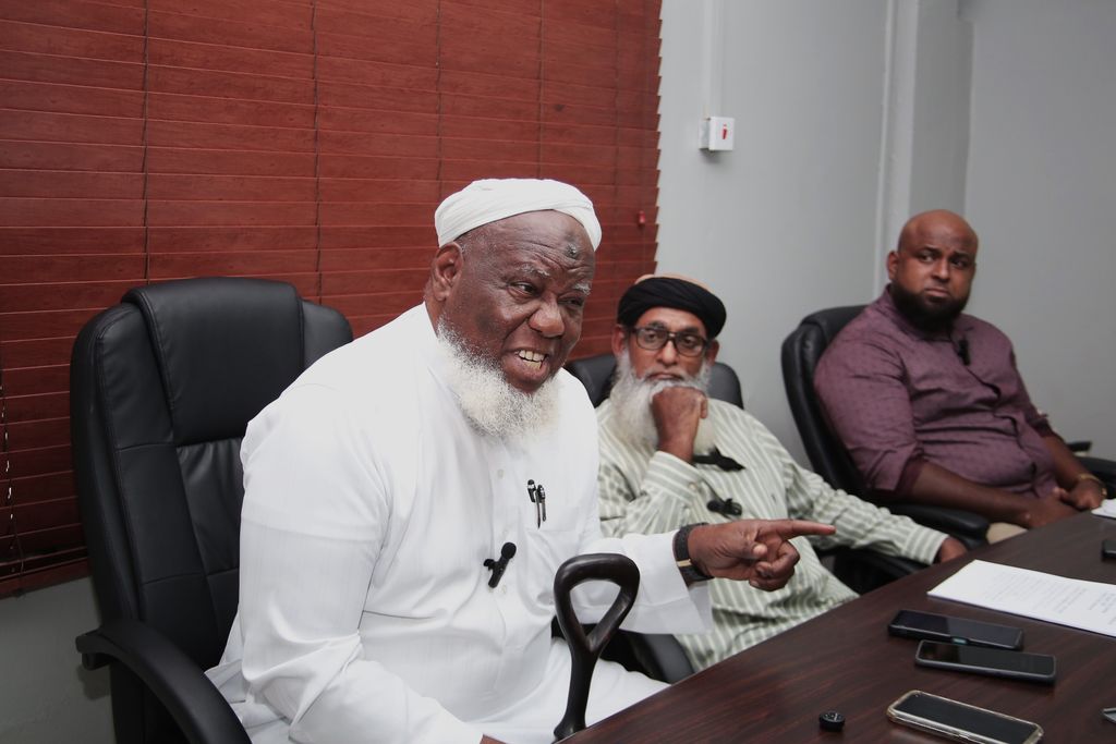 Hassan Ali, the father of prisoner Rajaee Ali, addresses members of the media during a press conference in San Fernando yesterday. Also in the photos are social activist Umar Abdullah, centre, and social media activist Vishal Persad. 