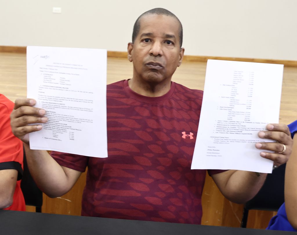 Calypsonian Roger “Bodyguard” Mohammed holds up two letters during a media conference at the Belmont Community Centre, Belmont, on Saturday.